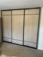 Cotta Cremona Oak doors with 1/8 strips at the top and bottom in brushed black frames, fitted in Great Ayton